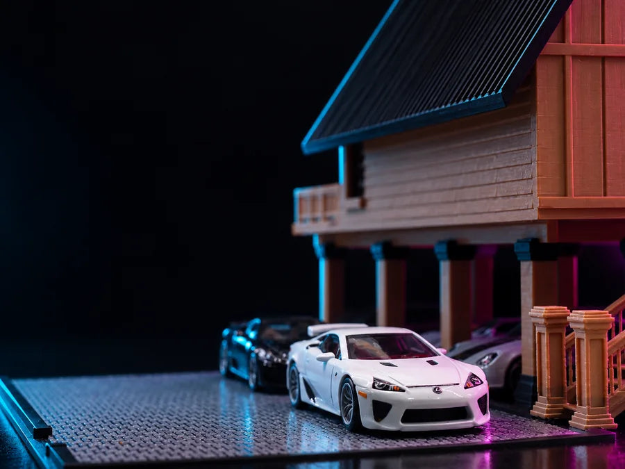 Frame 3 — close up at deck level, a car on the textured pad beside the timber wall and the stair balusters.
