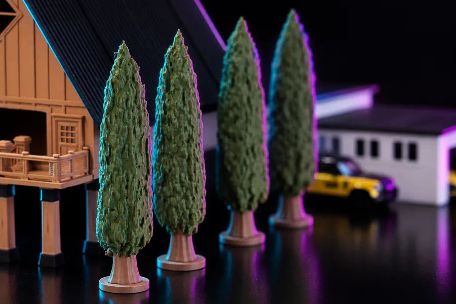 Frame 3 — the wider view along the street, the trees in a line between the barn on one side and a white building and a parked car on the other.