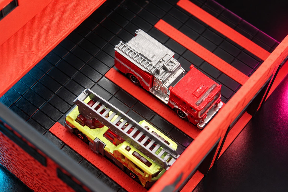 Bay roof lifted off the fire station diorama, a pumper and a ladder truck parked inside