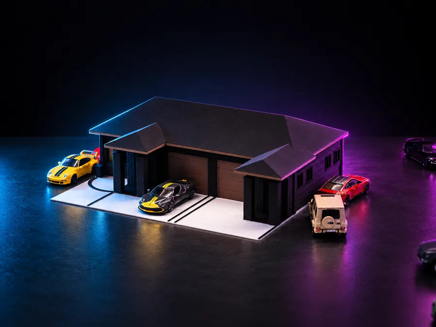 Frame 2 — the whole piece from above and to one side, the hip roof running the full width, the apron scored in front of it and four cars standing around the plate.
