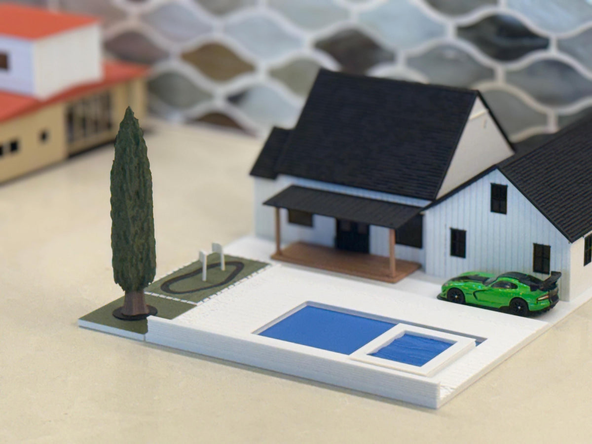 Green diecast sports car in the backyard of the 1:64 modern farmhouse beside the pool and putting green