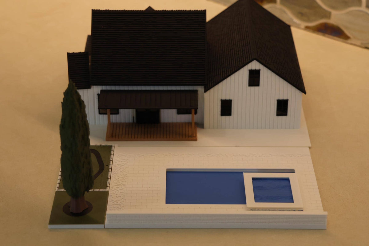 Rear view of the 1:64 modern farmhouse with the backyard pool and cypress tree