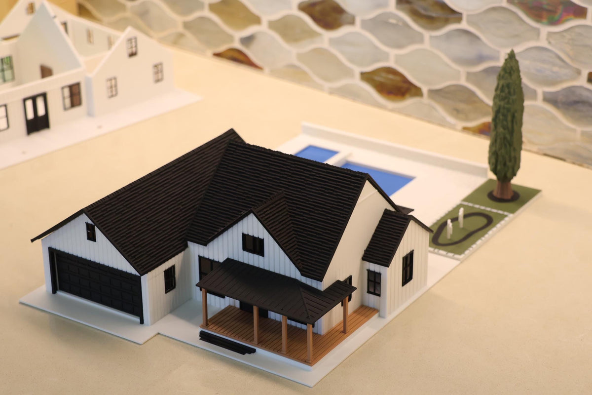 Front three-quarter view of the 1:64 farmhouse, two-car garage and front porch
