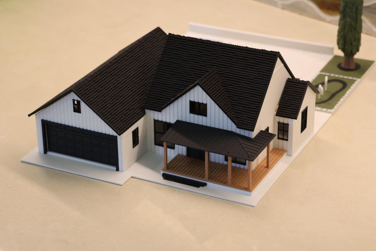 1:64 modern farmhouse with white board-and-batten siding, black garage door and front porch