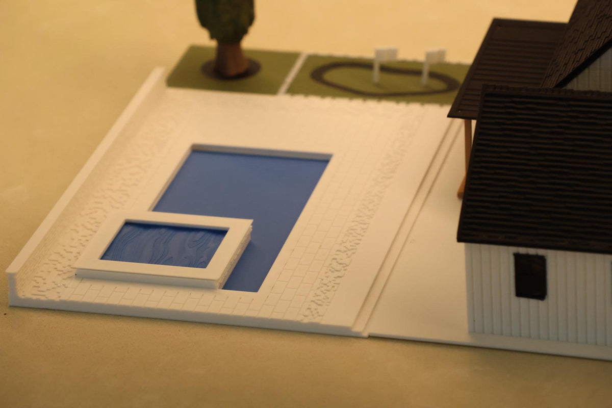 Close-up of the backyard pool and putting green on the 1:64 farmhouse base