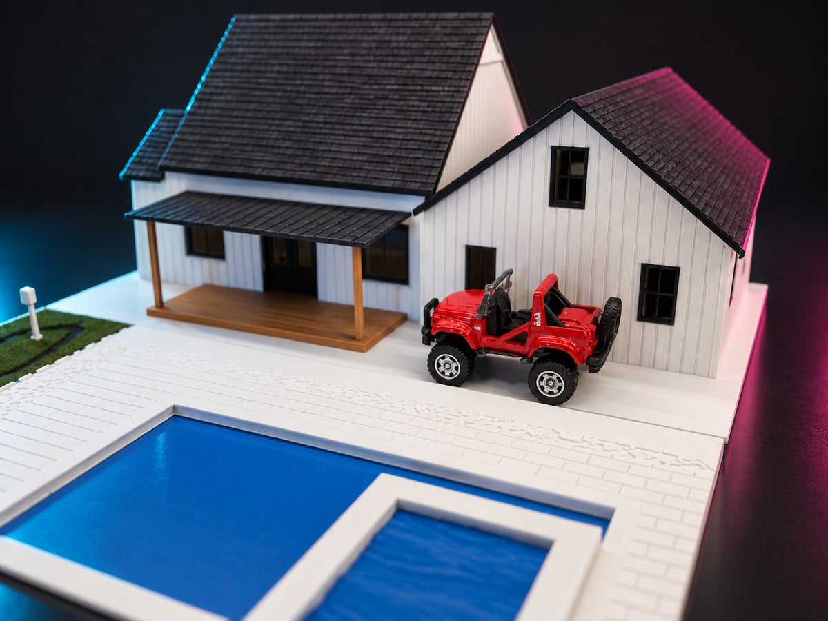 Red diecast off-roader on the pool deck behind the 1:64 modern farmhouse