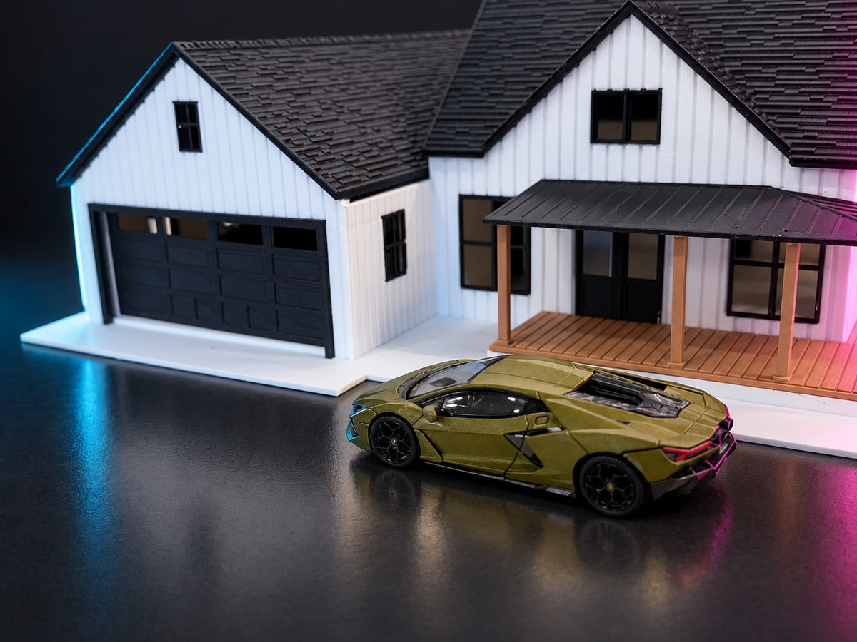 Olive diecast supercar parked at the 1:64 farmhouse garage, close-up