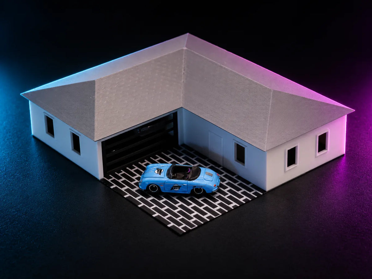 A printed single-storey suburban house lit in cyan and magenta, bone walls under a silver-grey hipped roof, laid out in an L around an open garage bay with a car on the brick apron.