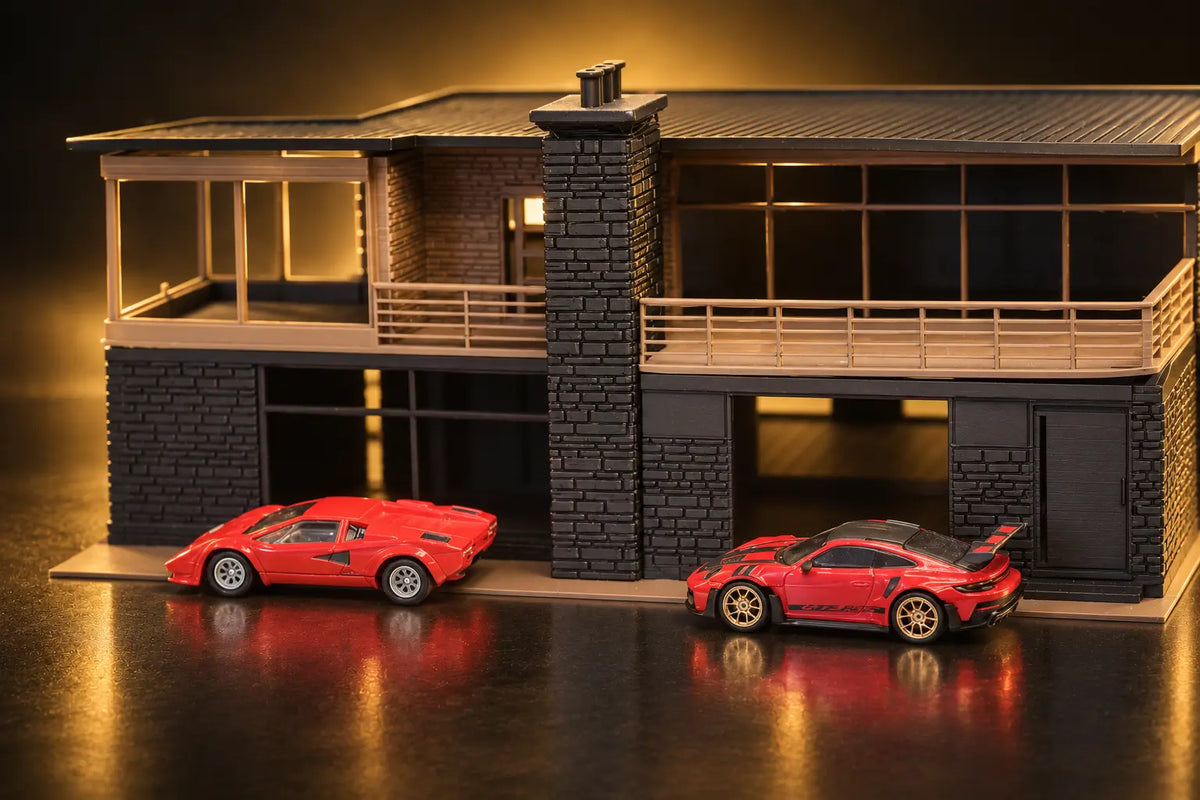 Tahoe Modern straight on: the stone chimney between the two decks, two red cars parked along the front.