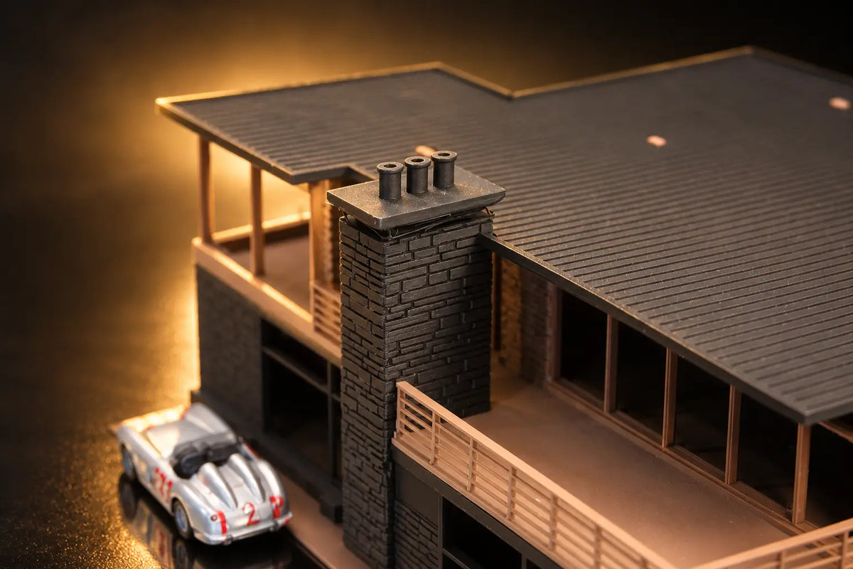 In close on the chimney and its three pots, a silver roadster parked below.