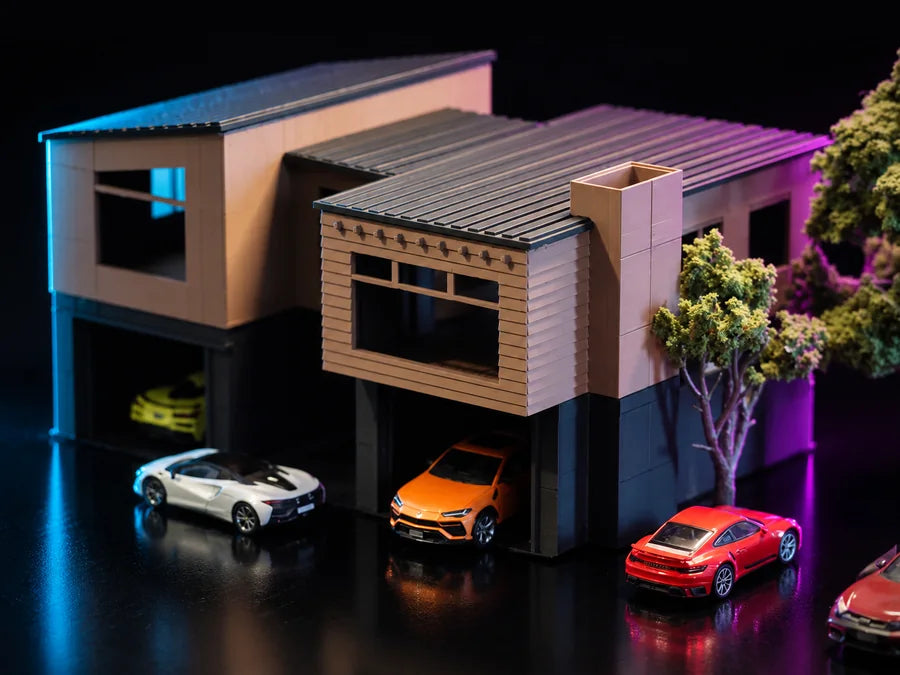 Frame 2 — closer in from the other side, the sectional garage door under the ribbed upper wall and a lit tree at the corner of the plate.